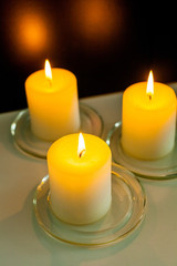 closeup to burning candles in darkness