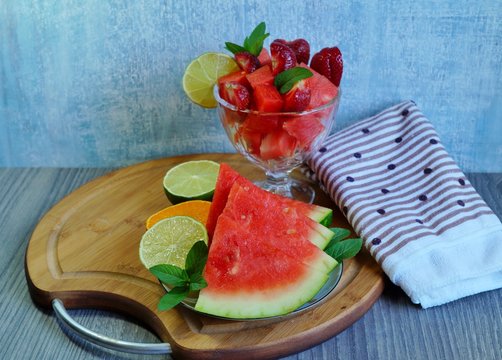 Watermelon. Fresh and juicy watermelon sliced on a white plate and diced glass dish - selective focus
