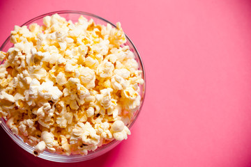 bowl with popcorn on red background
