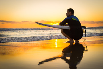 Surfer on the Beach at Sunrise or Sunset