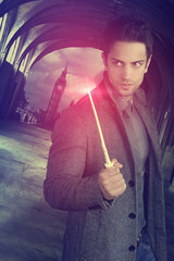 handsome wizard holding a magic wand