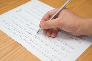 Obraz premium filling test score sheet with ballpoint