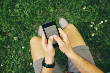 Man using cellphone outdoors.