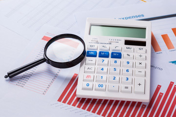 Calculator and magnifying glass on the table