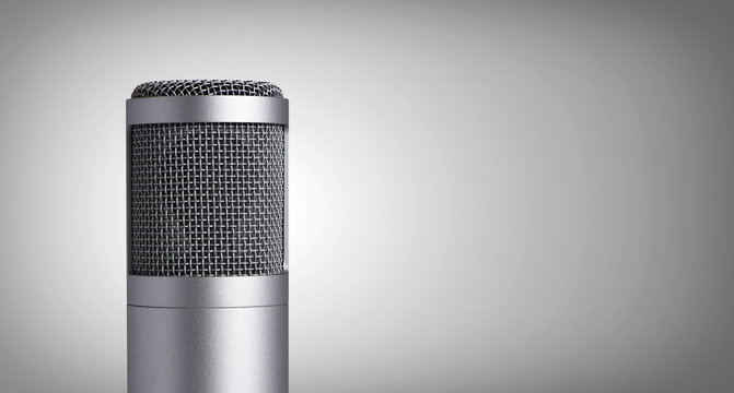 Vintage microphone on gray background
