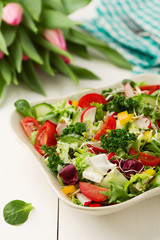 Spring salad with fresh vegetables from radishes and kale