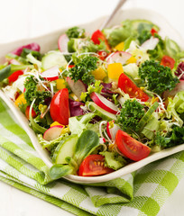 Spring salad with fresh vegetables from radishes and kale