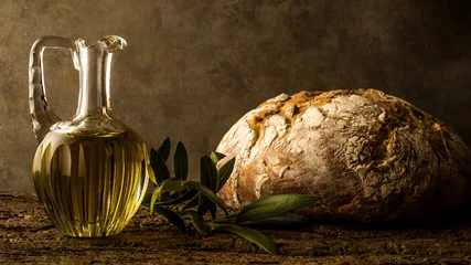 Gordijnen Virgin olive oil in vintage oil jar and rustic bread © Maruba