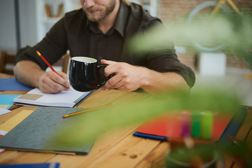 Portrait of a young designer/architect/businessman at work in his home office
