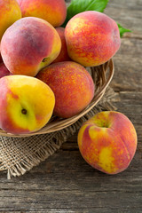 ripe peaches on wooden surface