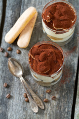 tiramisu in glass on wooden surface