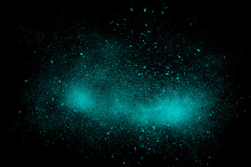 Cyan abstract powder explosion on a black background