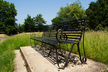 Black park bench on a concrete base