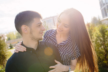 Girl hugging her boyfriend Strong Back light and lens flare