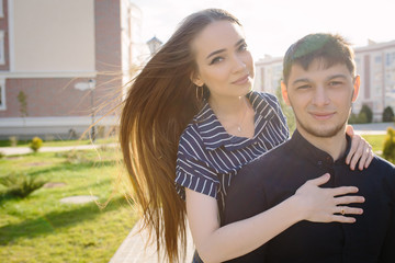 Fototapeta premium Girl hugging her boyfriend Strong Back light and lens flare