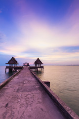 Walking path leading to the sea with twilight sky background © pranodhm