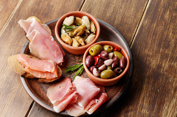 Tapas of salmon, mussels, jamon and olives