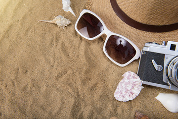 Fototapeta na wymiar beach accessories on wooden board,Straw hat,sunglasses on wood