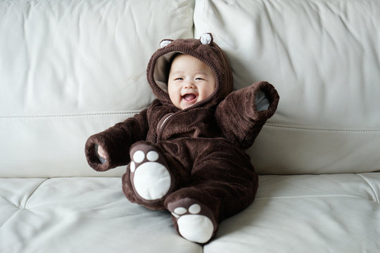 Asian newborn baby wearing bear suit