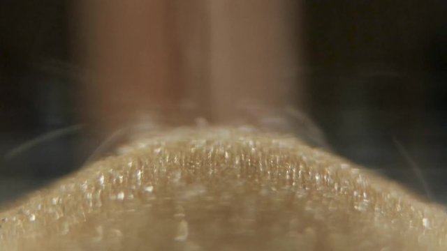 Jet of sand. Sand flowing. Close up