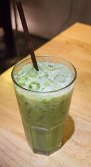 Ice milk green tea on wooden table