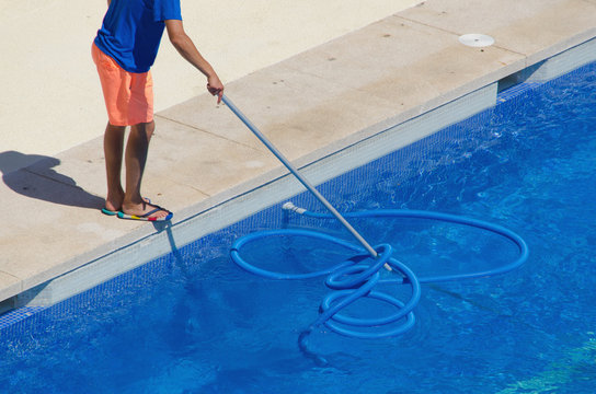 janitor cleaning the swimming pool