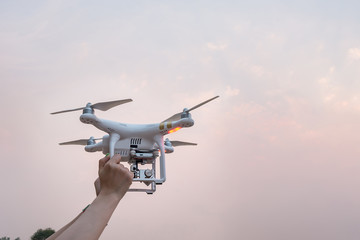 Woman Hand holding Drone at sunset