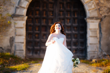 happy bride on the background of old wooden door