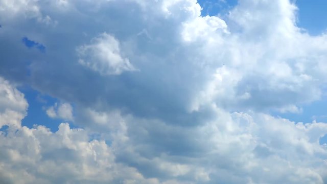 Time lapse clip of morphing white clouds over a blue sky