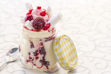 Ice cream in a glass jar with some berries