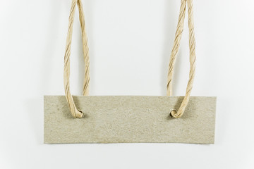Aged paper tags with simple traditional strings, isolated on white background.