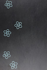 Group of funny paper clips on a dark stone background, a lot of
