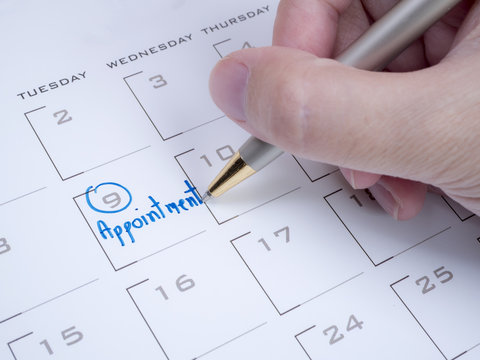 Woman hand write appointment on calendar 1