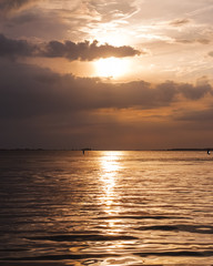 Fototapeta premium Blazing and vibrant orange summer sunset over Venice lagoon 