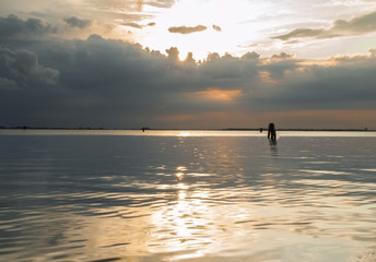 Fototapeta na wymiar Stormy sunset over Venice lagoon.