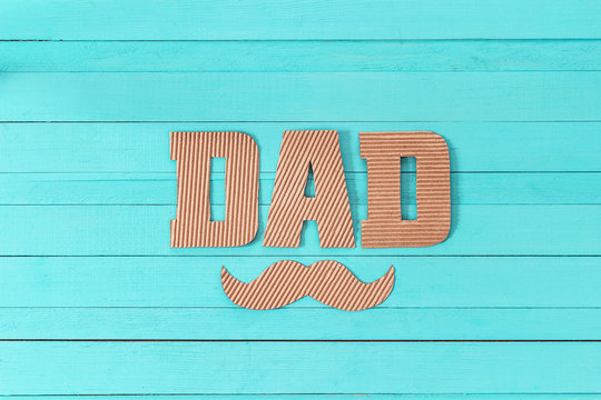 Fathers day background with cardboard letters and mustache.