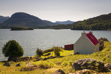 Scotland. Applecros. May 2016. A red roofed croft on the shores of Loch Shieldaig, on the Applecross peninsula in Wester-Ross, Scotland. © espy3008