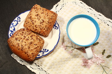bun and cup of milk on a napkin