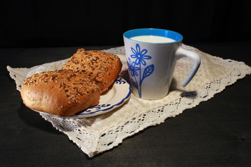 bun and cup of milk on a napkin