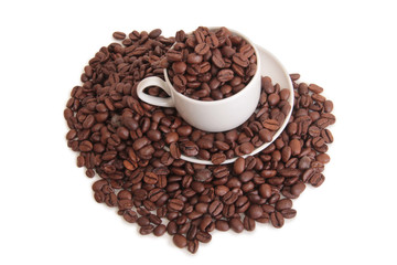 Coffee beans and a white cup on white background