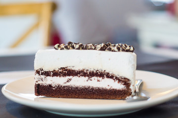 White chocolate cake in white plate at cofee shop