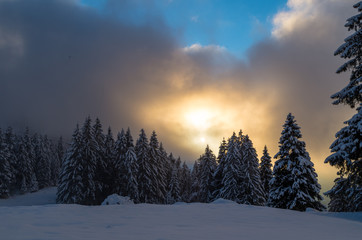 Winter scene with sunset in mountains