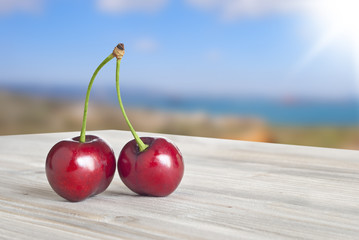 cherry on a rustic wooden ,blue sky background 