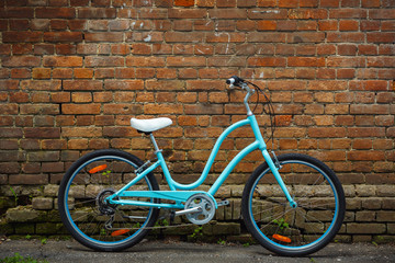 Blue vintage bicycle with old brick wall