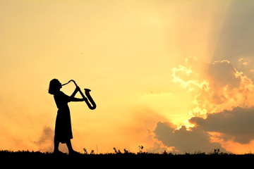 Silhouette children playing musical at sky sunset .warm tone