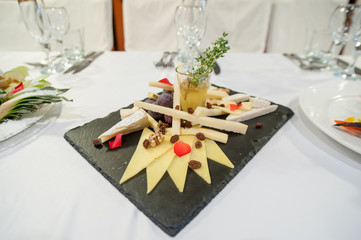 Served festive candy bar table with cupcakes tower and love is sweet sign