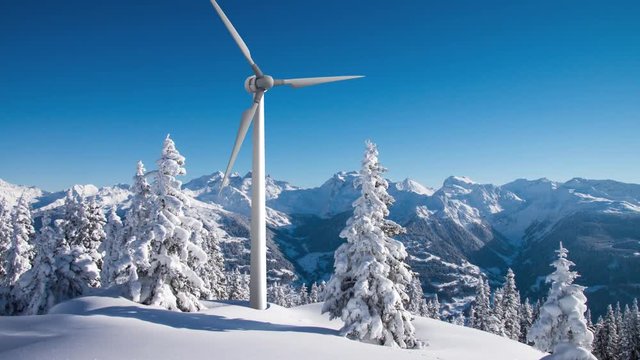 Rotating wind turbine above sunny snowy forest in the mountains 4K footage