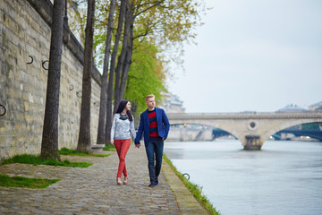 Romantic couple in Paris near the Seine