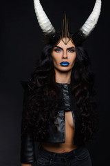 beautiful girl with horns on his head on a black background