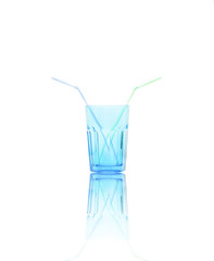empty blue water glass with two straws isolated on white background with reflection